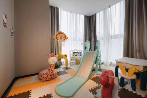 a childs play room with a slide and play equipment at Echarm Hotel Nanning the MixC Dongmeng Business District in Nanning