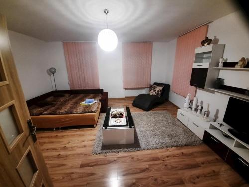 a living room with a couch and a table at Ubytovanie pod hradom Krásnohorské Podhradie in Krásnohorské Podhradie