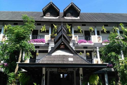a building with a building with a roof at Baan Orawee Boutique Hotel in Mae Rim