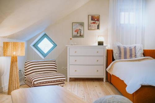 a small bedroom with a bed and a chair at Saieta 2 Apartment II in Madona