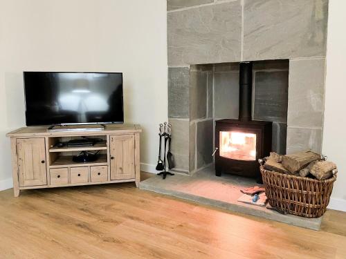 a living room with a television and a fireplace at Glenview - Ukc6856 in Millton of Clova