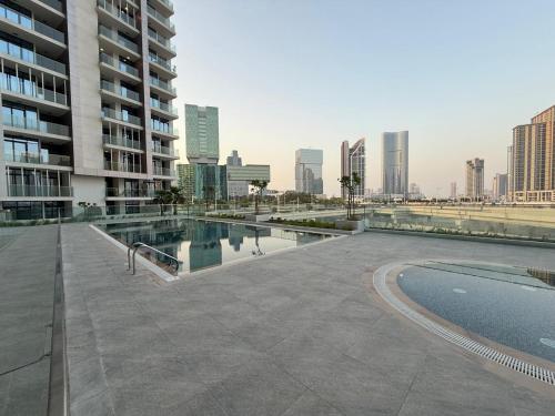 a swimming pool in the middle of a city at 1 Bedroom in Maryah Island by Central Stay 1 min to Cleveland, Galleria Mall and ADGM in Abu Dhabi