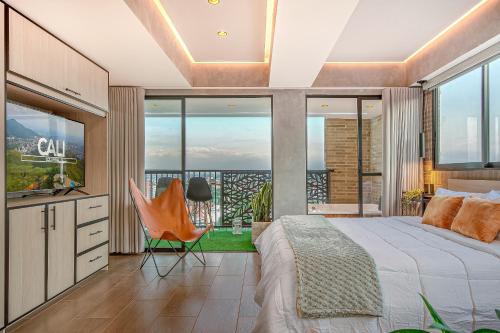 a bedroom with a king sized bed and large windows at Edificio Habitare Cristales Cali 2 in Cali