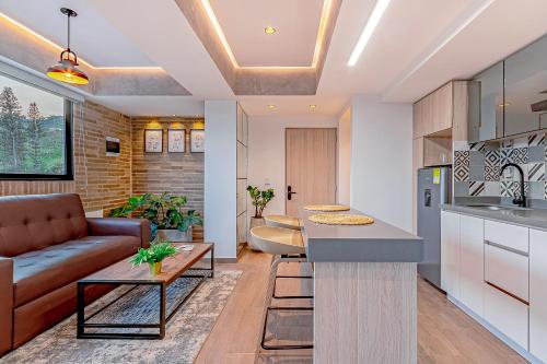 a kitchen and living room with a couch and a table at Edificio Habitare Cristales Cali 2 in Cali