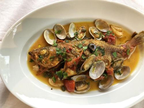 a plate of food with a fish and mussels at HOTEL HOLIDAY HOME in Kyotango