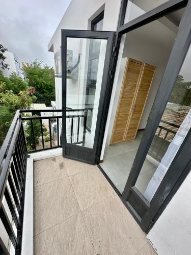 an open door of a house with a balcony at Lotus D`Or Villa in Trou aux Biches