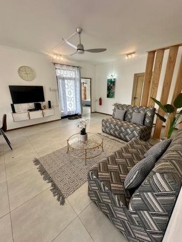 a living room with a couch and a table at Lotus D`Or Villa in Trou aux Biches