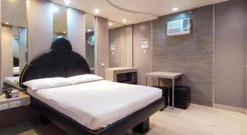 a bedroom with a large bed in a room at One Serenata Hotel General Trias in Silang