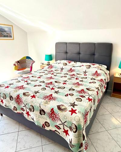 a bedroom with a bed with a blanket with fish on it at Apartments Barbara 111 in Vir
