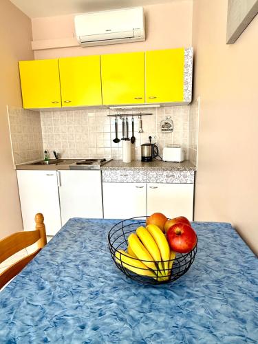a bowl of fruit on a table in a kitchen at Apartments Barbara 111 in Vir