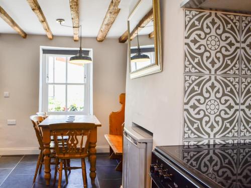 a dining room with a table and a window at Troedyrhiw Isaf in Tregaron
