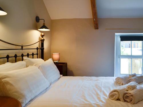 a bedroom with a white bed with towels on it at Troedyrhiw Isaf in Tregaron