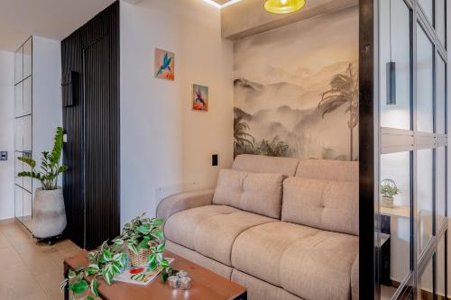 a living room with a couch and a painting on the wall at Edificio Habitare Cristales Cali 2 in Cali
