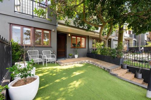 a house with a small yard with a lawn at Inner City Townhouse in Brisbane