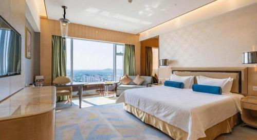 a hotel room with a bed and a large window at Shanghai Fuyue Hotel in Shanghai