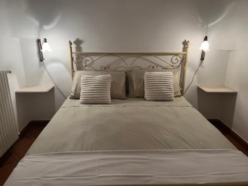 a bed with two pillows on it in a bedroom at Trulli Capomazza in Noci
