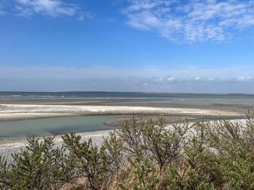 a beach with a body of water and some trees at Gite entre Mer et Vallée à Embreville in Embreville