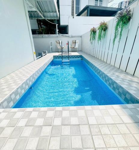 a swimming pool on the roof of a building at Private Pool Villas Sukhumvit 26 Near BTS Phrom Phong and EmSphere in Bangkok