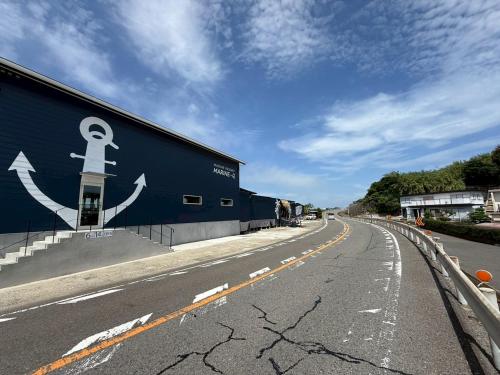 a building with an anchor painted on the side of it at MARINE-Q in Inami