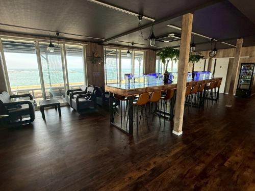 a room with a bar with chairs and a table at MARINE-Q in Inami