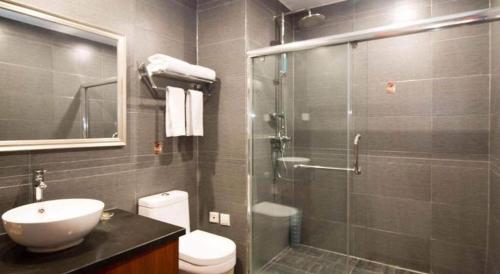 a bathroom with a shower and a toilet and a sink at James Joyce Coffetel Xian Dayanta Metro Station Branch in Xi'an