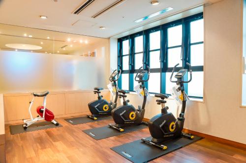 a gym with three exercise bikes in a room at Hotel Nikko Nara in Nara