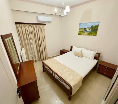 a bedroom with a bed and a dresser in it at D&S Coastal Stay in Korinthos in Korinthos