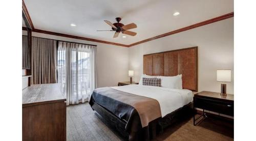 a bedroom with a large bed and a ceiling fan at Luxury 1 Bedroom At The Hythe In Lionshead Village in Vail