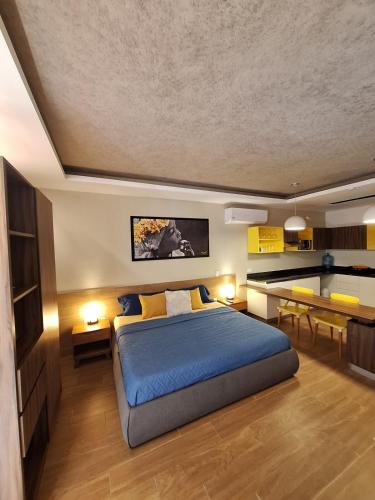 a bedroom with a bed and a dining room at George Luxury Condo in Playa del Carmen