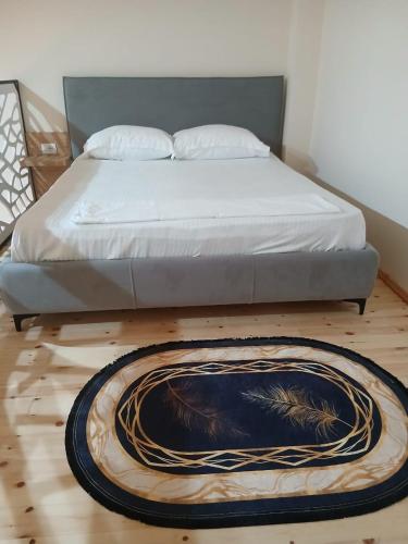 a bedroom with a bed and a rug on the floor at ED Living in Orikum
