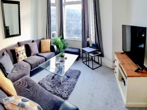 a living room with a couch and a tv at Hill View in Abertillery
