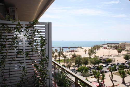a balcony with a view of the beach at La Casa Sul Mare in Civitavecchia