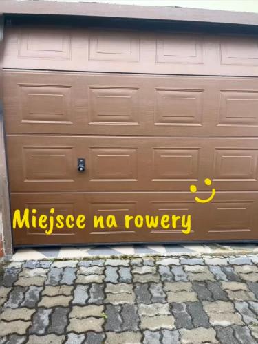 a garage door with a sign that reads mikelez ma journey at Willa Rodzinna in Mielno