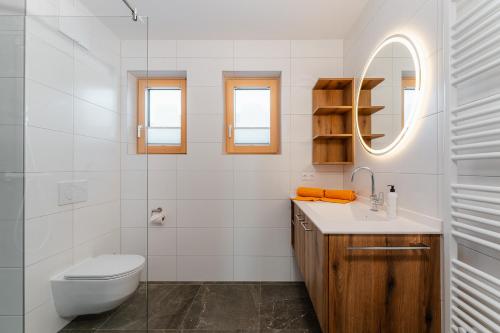 a bathroom with a toilet and a sink and a mirror at Ferienwohnungen Leitner-Ebenberger in Greifenburg