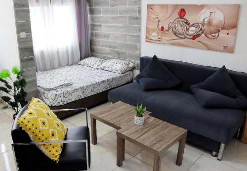a living room with a couch and a table at Eilat Apartments - דירות נופש באילת in Eilat