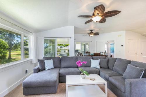a living room with a couch and a ceiling fan at Pili Aloha in Princeville