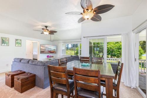 a dining room with a table and a couch at Pili Aloha in Princeville