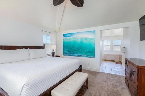 a bedroom with a large bed and a bathroom at Pili Aloha in Princeville