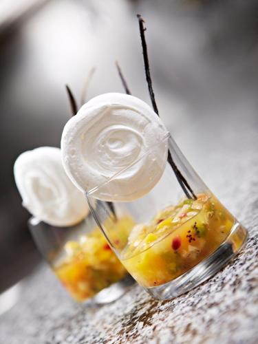 a couple of glasses filled with food on a table at Hôtel Mets et Plaisirs in Mazamet
