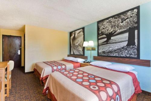 a hotel room with two beds and a picture on the wall at Super 8 By Wyndham Lexington Park/California Area in California