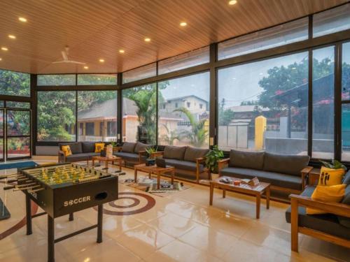 a living room with a couch and a foos ball at The Hosteller Lonavala, City Centre in Lonavala