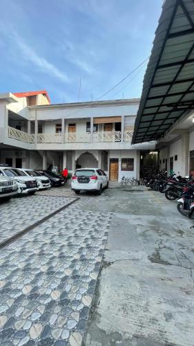 a car parked in a parking lot in front of a building at Homestay Yaa Syafi in Bireun