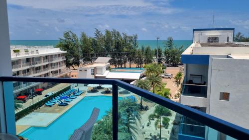 a view of the pool from the balcony of a resort at Grandblue condominium 609 in Mae Pim