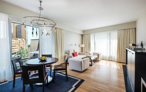 a living room with a table and a couch at Grand Hyatt Berlin in Berlin