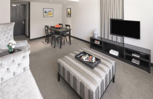 a living room with a couch and a table at Southern Sun Cape Sun in Cape Town