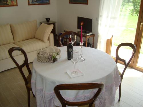 a dining room table with a candle and wine glasses at La Sosta di Braccio in Macchie