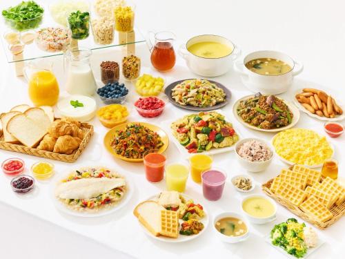 a table filled with different types of food at Comfort Hotel Nagoya Shinkansenguchi in Nagoya