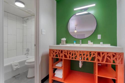 a bathroom with a sink and a mirror at Heights House Hotel - Houston Heights Downtown, an Ascend Collection Hotel in Houston