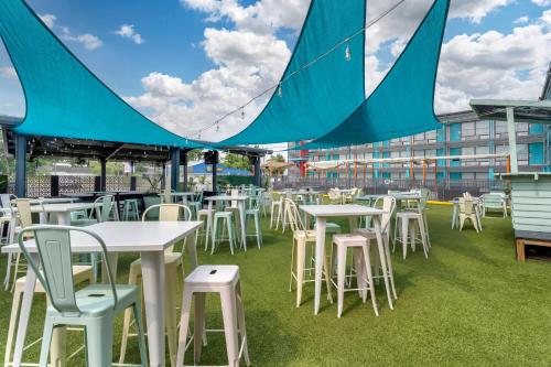a group of tables and chairs on the grass at Heights House Hotel - Houston Heights Downtown, an Ascend Collection Hotel in Houston