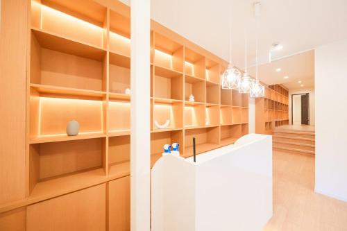 a kitchen with wooden shelves and a white counter at Starry Stay Villa NISHIATAMI in Atami